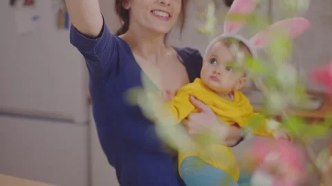 Mother with baby decorating easter eggs. Stock Footage 175998379