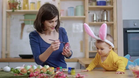 Mother With Baby Decorating Easter Eggs. Stock Footage 177403678