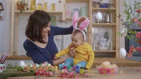 Mother With Baby Decorating Easter Eggs. Stock Footage 177405528