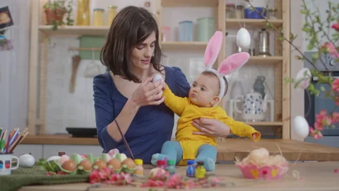 Mother With Baby Decorating Easter Eggs. Stock Footage 177542618