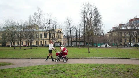 Mother WIth Baby Pram in Park Stock Footage