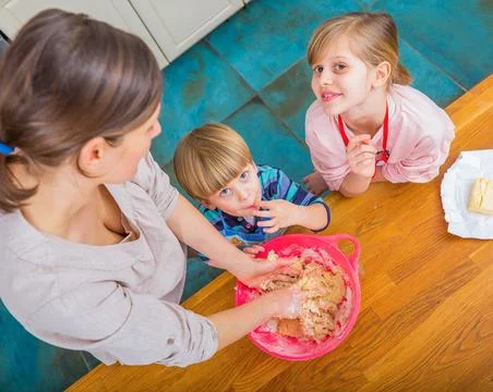 Mother Baking with Kids While Making Cookie Dough in Kitchen Stock Photos