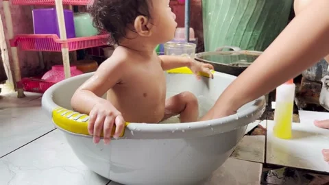 A mother is bathing her child Stock Footage 212558661