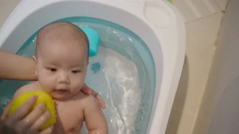 Mother Bathing her liitle son in bathroom at home. Stock Footage 156893575