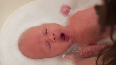 How To Bathe A Newborn Baby Boy Video : Cute Little Boy Taking Bath And Douche Little Child In A Bathtub Smiling Kid In Bathroom With Colorful Toy Infant Washing And Bathing Hygiene And Care For Young Children Video By C / There's no need to give your newborn a bath every day.