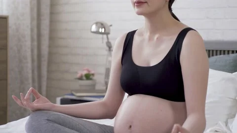 Mother-to-be is meditating on bed Video stock 144550749