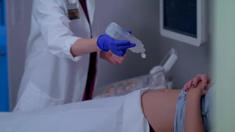 A MOTHER BEING PREPPED FOR A SONOGRAM 스톡 동영상 108045281