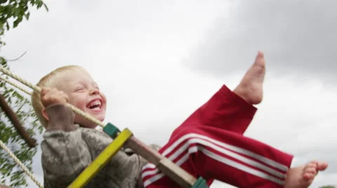 Mother Boy Swing Joy Clouds - 4k - Slow motion Stock Footage 61109276