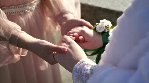 Mother of the bride's hand holding the bride's hand on the wedding day Stock Footage 272334099