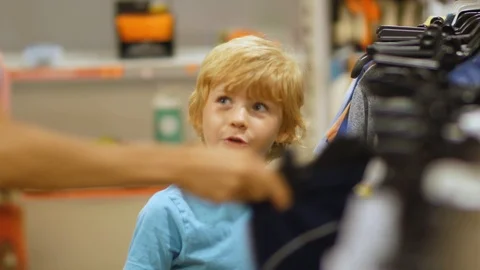 Mother Buys Clothes For Son In The Store Stock Footage 93784332