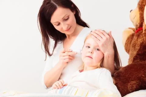 Mother Checking Her Daughter's Temperature 写真素材