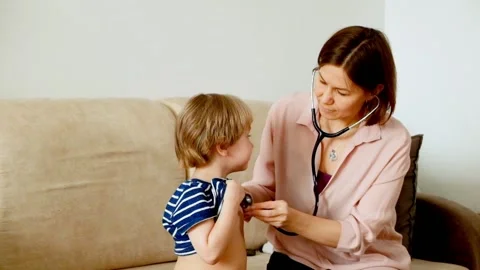 Mother checking a son with stetoscope Stock Footage 87747036