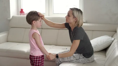 Mother checking temperature of her sick son. Sick child with fever and illness Stock Footage 91355816