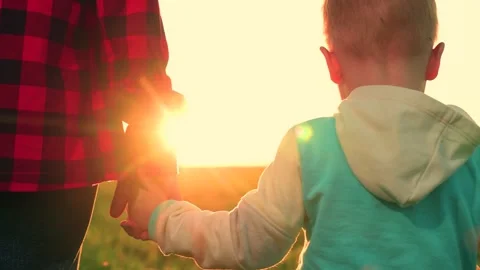 Mother child join hands, going to take quiet walk in field. Dreamy toddler baby Stock Footage 282891015