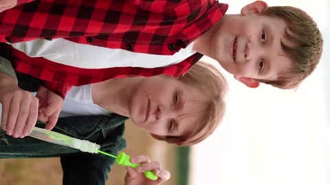 Mother child kid Son Soap Bubbles, happy family, plaid shirt, laughter popping Stock Footage 296319782