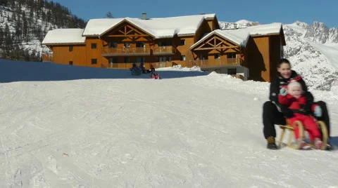 Mother with child sliding down on sled Vidéo 44882069