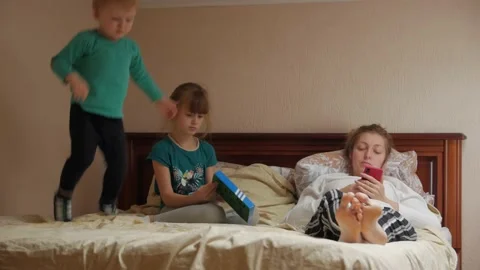 Mother With Children On The Bed Stock Footage 143418212