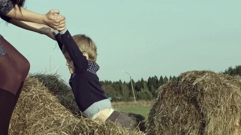 Mother with children playing on a haystack. Stock Footage 84185958