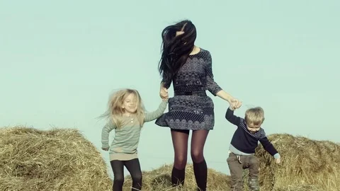 Mother with children playing on a haystack. Stock Footage 84185973