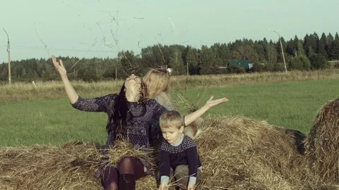 Mother with children playing on a haystack. Stock Footage 84186229