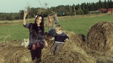 Mother with children playing on a haystack. Stock Footage 84193547