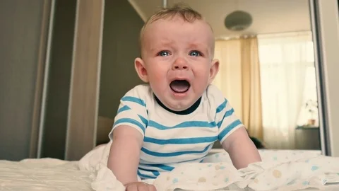 Mother comes to a crying baby to change his diaper Stock Footage