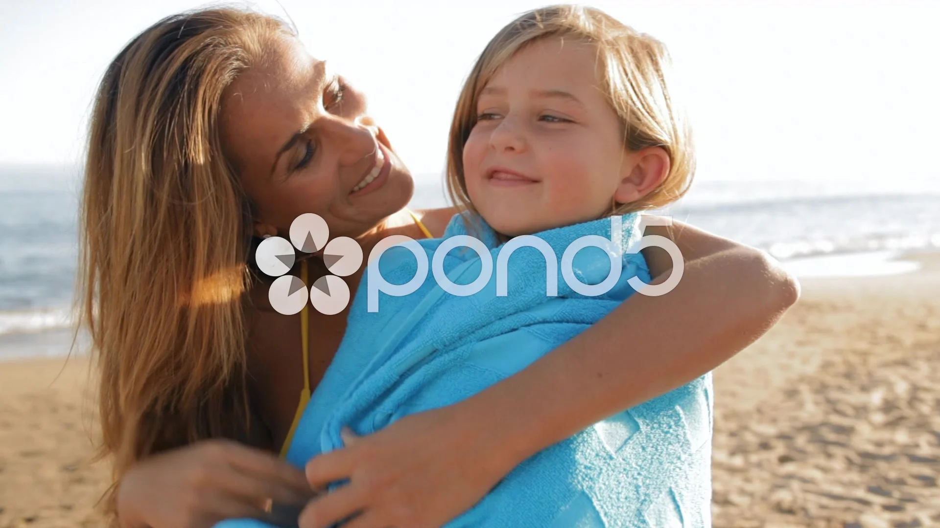 Grandmother And Granddaughter Wrapped In Towels Smile As They