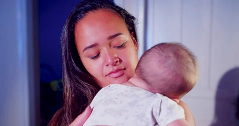 A mother is cuddling her child while the baby is sleeping Видео 170730823