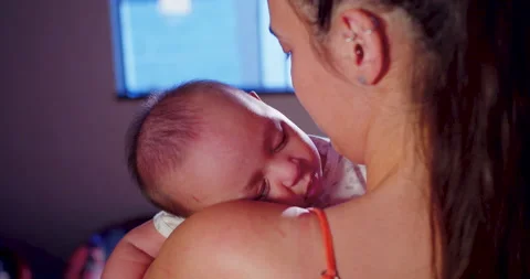 A mother is cuddling her child while the baby is sleeping Stock-Footage 170730829