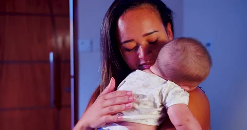 A mother is cuddling her child while the baby is sleeping Stock-Footage 170730831