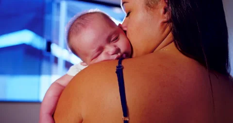 A mother is cuddling her child while the baby is sleeping Stock-Footage 170731043