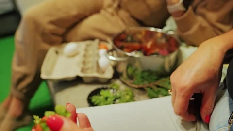 Mother, Daughter Decorate Easter Egg With Plants for Cherished Family Tradition Stock Footage 344008066
