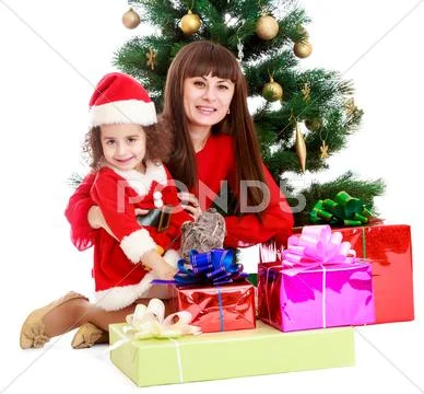 Mother with daughter near the Christmas tree Stock Photos