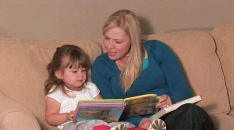Mother & Daughter Reading a Book Stock Footage