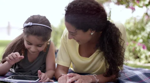 Mother with daughter using digital tablet at park. Stock Footage 63511002