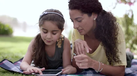 Mother with daughter using digital tablet at park. Stock Footage 63511035