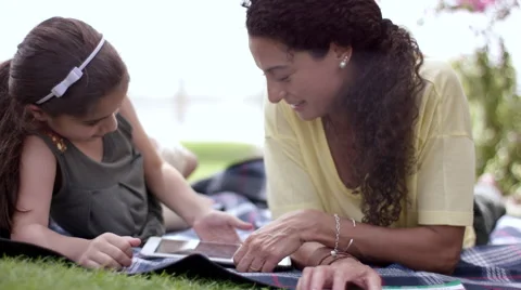 Mother with daughter using digital tablet at park. Stock Footage 63511042