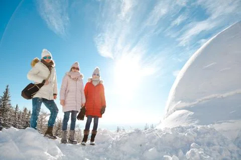Mother with daughters posing on a snow 스톡 사진