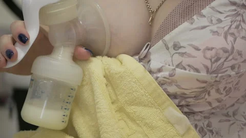Mother decanting milk breast pump Stock Footage 99759708