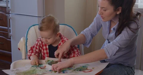Mother Developing Creativity with Child Drawing with Finger Paints 스톡 동영상 101375690