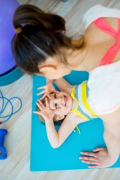 Mother is doing exercises Stock Photos