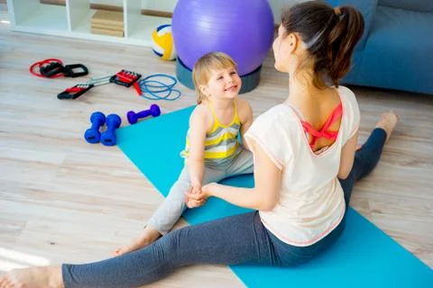 Mother is doing exercises Stock Photos