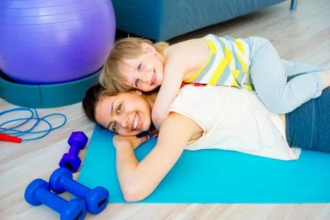 Mother is doing exercises Stock Photos