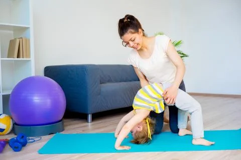 Mother is doing stretches Stock Photos