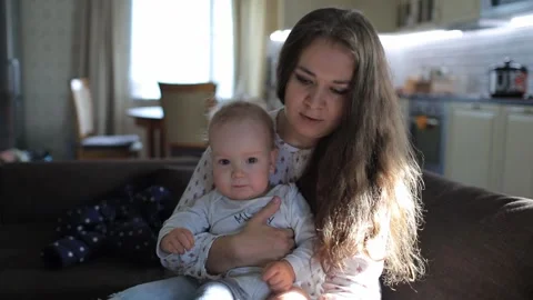 Mother dresses a small child Stock Footage 131632425