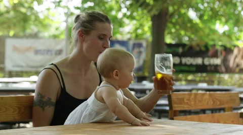Mother Drink Beer Baby Shake - 4k Stock Footage 59162175