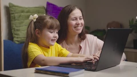 Mother engaged school program home with her child digital laptop. parental 스톡 사진