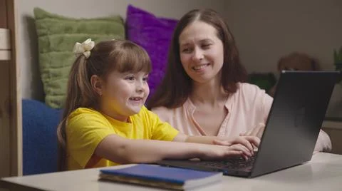 Mother engaged school program home with her child digital laptop. parental 스톡 사진