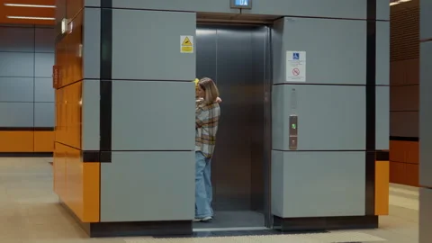 Mother entering elevator with child in subway station Stock Footage 302473899