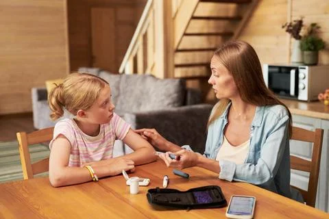 Mother Explaining Insulin Pen Injection to Daughter at Home Stock Photos